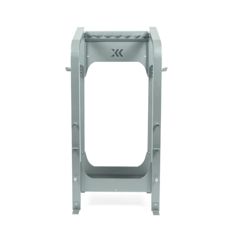 The Exxentric kBox Advanced Accessory Rack is a gray metal stand with a rectangular frame and logo near the top, featuring a sturdy, industrial design to support or hold objects.