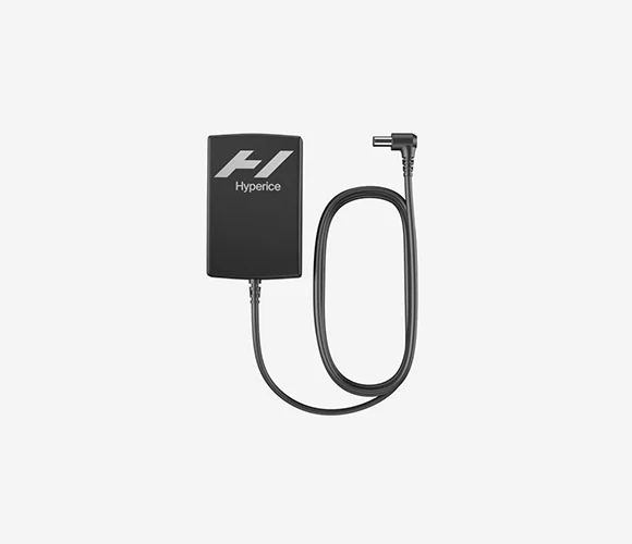 A Normatec 3 Power Supply, featuring a black charging adapter with an attached cable and an angled connector end, set against a plain light gray background.