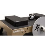 A close-up of Exxentric Elevation Blocks (2-pack), showcasing metal discs and a foot platform with clips. Designed for strength training and conditioning, it boasts a sleek, industrial look.