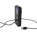 A Pocket Radar Smart Coach App System, featuring a black electronic device with a digital screen and buttons labeled SMART CHARG, connects to a visible right-angle USB cable plug against a white background.