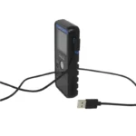 A Pocket Radar Smart Coach App System, featuring a black electronic device with a digital screen and buttons labeled SMART CHARG, connects to a visible right-angle USB cable plug against a white background.
