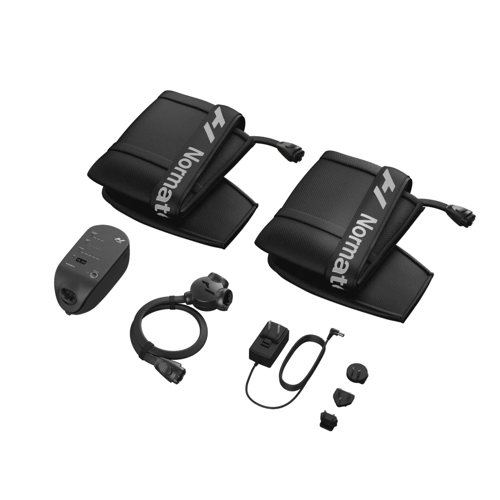 A set of black compression therapy devices, including two padded wraps with tubes labeled Normatec, a control unit, and connecting cables, arranged on a plain background.