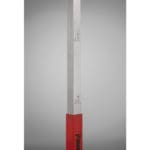A close-up of the PowerMax Vertical Jump Trainer, a red and silver measuring rod with markings in feet and inches from 60 to 70, against a simple gray gradient background.