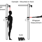 The Dashr Biostation provides height and wingspan measurement with a mounted rack. It displays height as a person standing upright, and wingspan with arms extended horizontally, with a scale underneath.