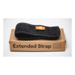A black Enode Extended Strap with an orange tag sits on a brown box labeled Extended Strap against a plain white background.