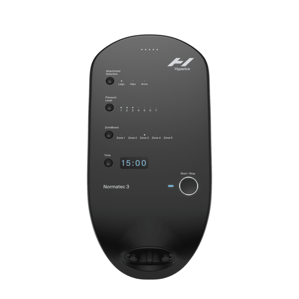 A black Normatec 3.0 Basic Unit features a digital display showing 15:00 and buttons for selecting body zones and pressure settings, designed for leg, hip, and arm compression therapy.