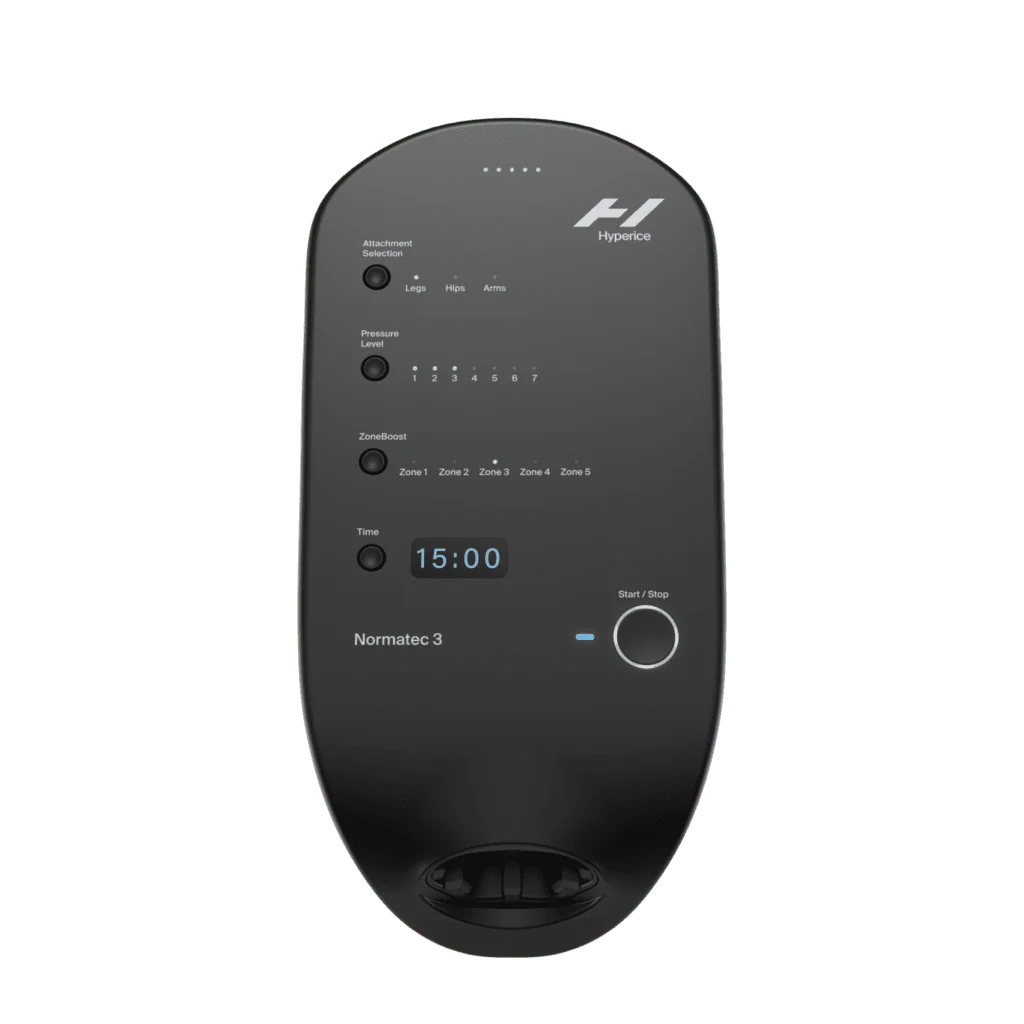 A black Normatec 3.0 Basic Unit features a digital display showing 15:00 and buttons for selecting body zones and pressure settings, designed for leg, hip, and arm compression therapy.