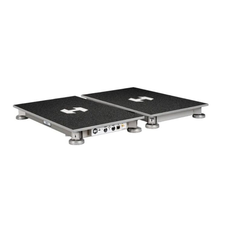 The Hawkin Dynamics Dual Force Plate features a double platform with four circular feet, a black surface, a white logo, and side ports for interfacing.