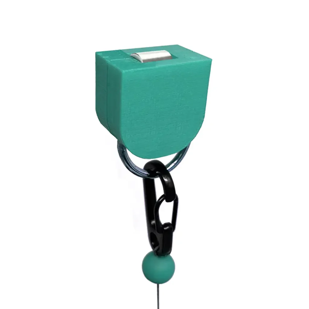 The Vitruve Roller Hook is a teal plastic device with a button on top, attached to a keyring and black carabiner clip. A string with a small green bead hangs below the device.