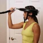 Female athlete demonstrating Iron Neck head gear.