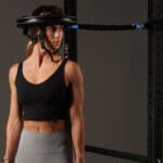 Athelte Demonstrating Iron Neck head gear and bungie cable