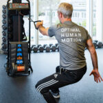 Athlete demonstrating the OHM Run Delta Kinetic Trainer.