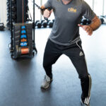 Athlete demonstrating rotation with the OHM Run Kinetic Trainer.