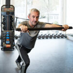 Athlete demonstrating push bar with OHM Run Kinetic Trainer.