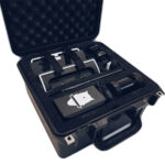A black, foam-lined Perch Camera case is open, showcasing various electronic components and accessories securely organized inside with straps.