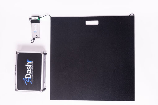 The Dashr Jump Mat and Controller, a black rectangular mat with an attached small electronic device, is shown next to a silver Dashr carrying case on a white background.