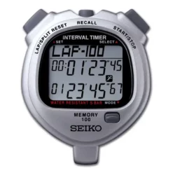 The Seiko S057 Interval Dual Timer Stopwatch features a silver design, displays lap time, timer, and memory on its screen, with buttons for lap/split reset, recall, and start/stop. Water Resistant 5 Bar is shown in red.