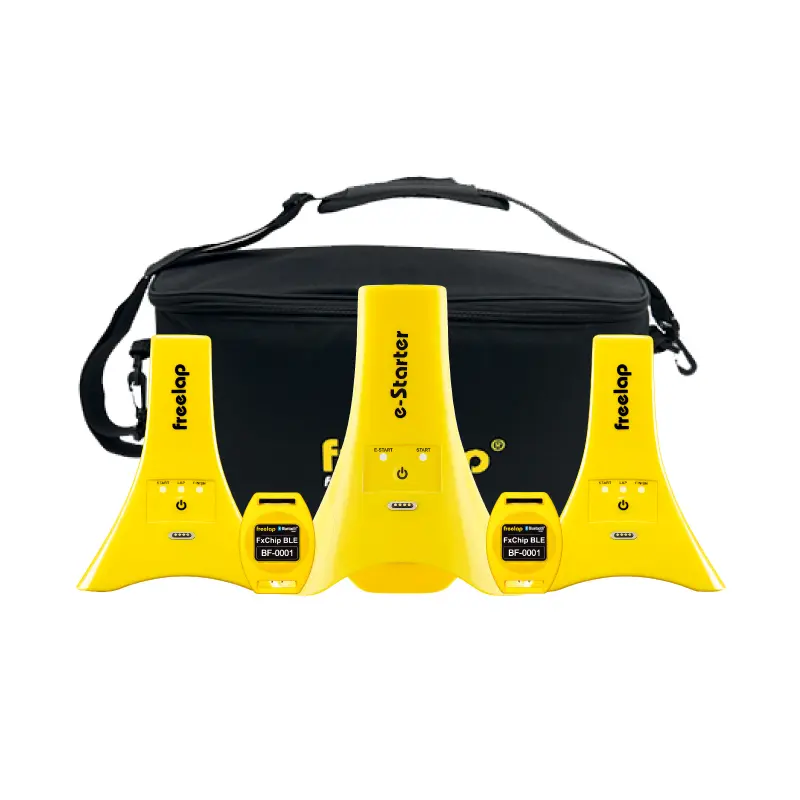A set of yellow Freestyle Pro timing sensors and transponders displayed in front of a black carrying case with a shoulder strap.