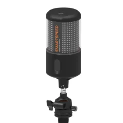 A black and transparent cylindrical VALD SmartSpeed Plus Timing Gate is mounted on a metal stand with adjustment knobs, designed for precise control in technical or scientific environments.