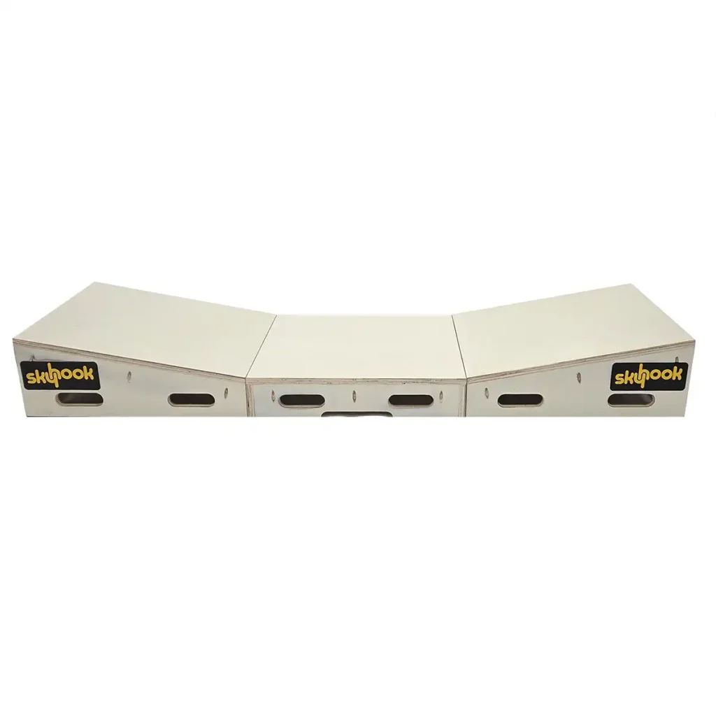 The Skyhook Modular Plyo Box is a wooden box with three connected sections, each featuring the skyhook logo. It forms a gentle V-shape and has side cutout handles for easy carrying.