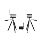 Two small black electronic devices with antennas are mounted on tripods, positioned facing each other. A third, smaller black device with an antenna sits on the ground between them.