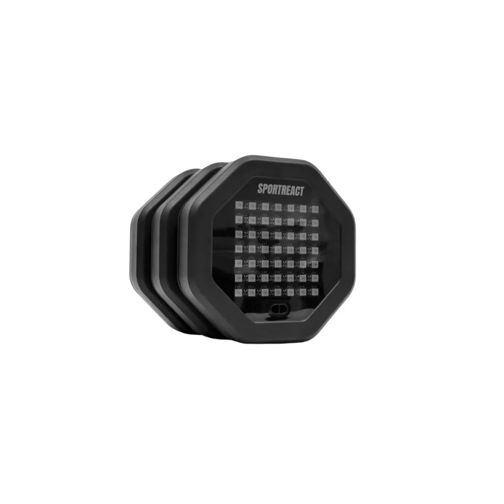 A black, octagonal electronic device labeled Sportreact Neo Kit | X3, featuring a grid of LED lights on the front, displayed against a white background.