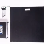 The Dashr Jump Mat and Controller, a black rectangular mat with an attached small electronic device, is shown next to a silver Dashr carrying case on a white background.