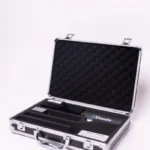 An open silver metal briefcase with a foam-lined interior displays a Dashr Jump Mat and Controller, featuring a black and blue Dashr-branded card and small electronic device, resting on a white surface.