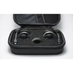The Enode / Eleiko - Bar Sensor Kit includes a black, hard-shell carrying case with two black headset earpieces nestled in foam and a mesh pocket inside the lid holding a cable. The background is plain white.