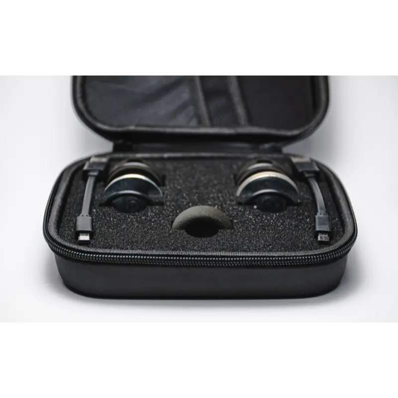 The Enode / Eleiko - Bar Sensor Kit includes a black, hard-shell carrying case with two black headset earpieces nestled in foam and a mesh pocket inside the lid holding a cable. The background is plain white.