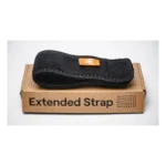 A black Enode Extended Strap with an orange tag sits on a brown box labeled Extended Strap against a plain white background.