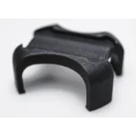 Close-up of the black, curved Enode Pro / Exxentric Flywheel Adapter, a small 3D-printed object with a textured surface and four arms, set against a sleek white background.