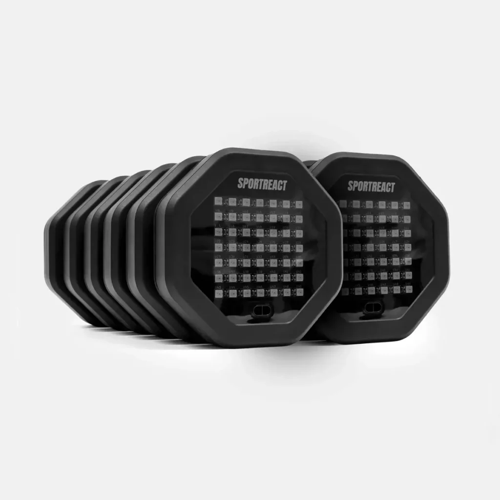 A set of twelve black, octagonal Sportreact Pro Lab Kit | X12 devices with LED grids on the front are arranged in a staggered row against a plain white background.