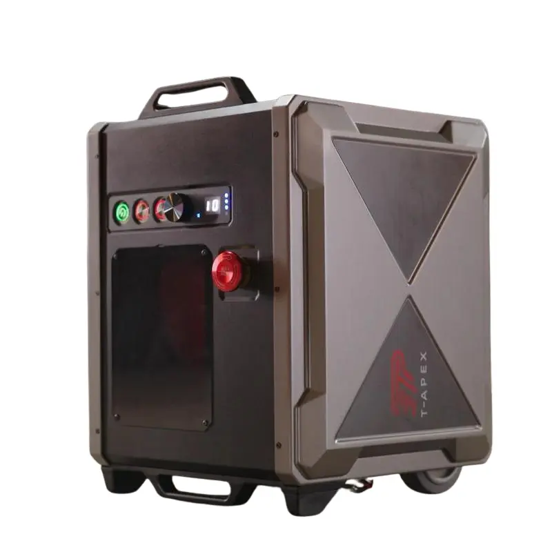 The TAPEX is a portable, rugged electronic device in black and gray with control knobs, buttons, a top handle, bottom wheels, and the TAPEX brand name on its side.