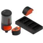 The VALD ForceFrame is a modular LED warning light system featuring a cylindrical light, two detachable battery packs, and a rectangular multi-slot charging dock, all in black and orange.